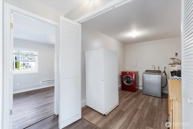 a view of a storage and utility room with washer and dryer