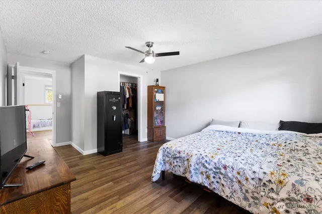a bedroom that has a bed and a flat screen tv