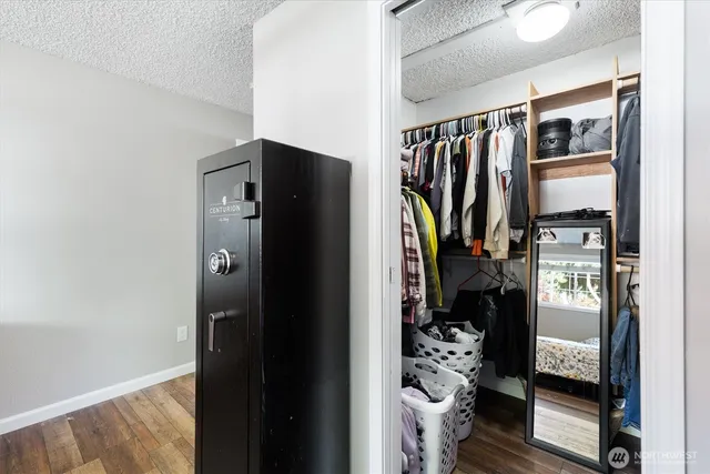 a view of walk in closet with clothes and shoes