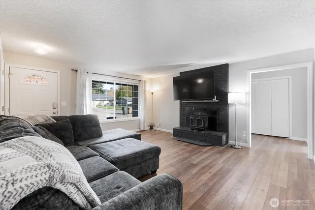 a living room with furniture flat screen tv and a fireplace