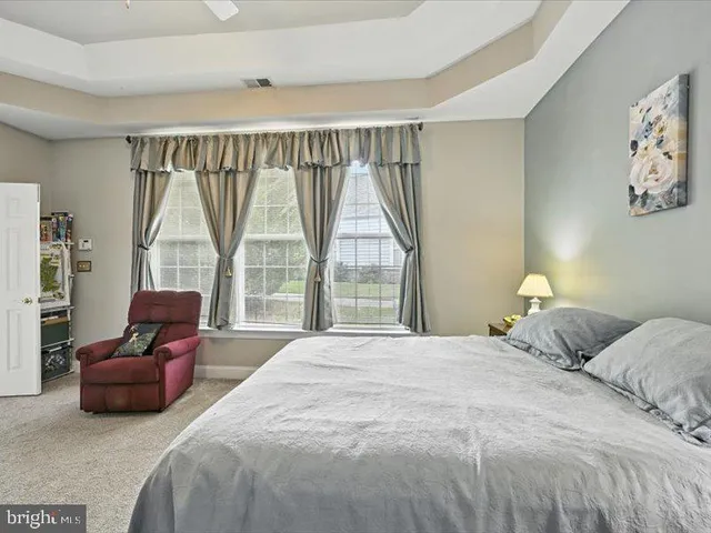 a bedroom with a bed and glass window