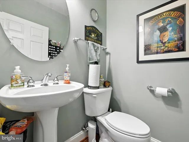 a bathroom with a toilet a sink and mirror