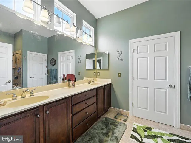 a bathroom with a double vanity sink and a mirror