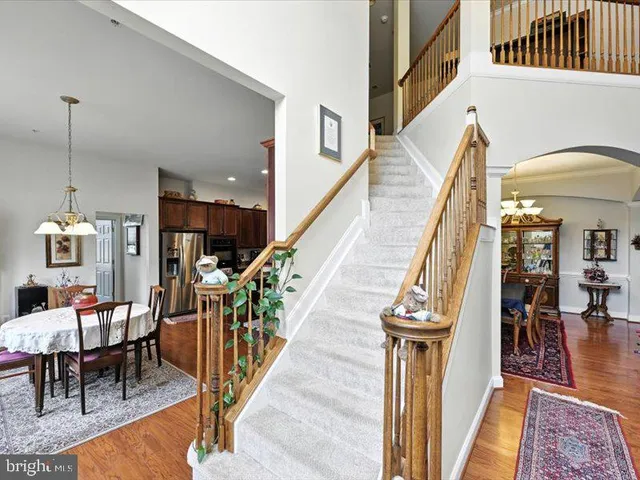 a dining room with furniture and wooden floor