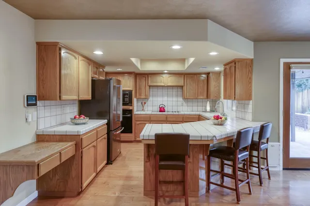 a kitchen with a sink dishwasher a stove and cabinets