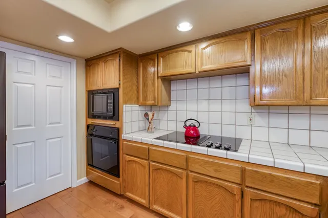 a kitchen with a sink cabinets and wooden floor