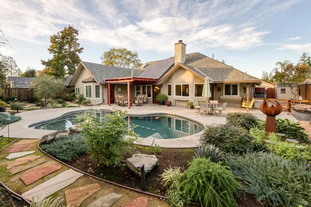 a view of a patio with table and chairs potted plants with wooden fence
