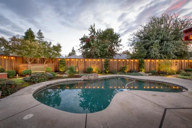 a view of a swimming pool with a yard