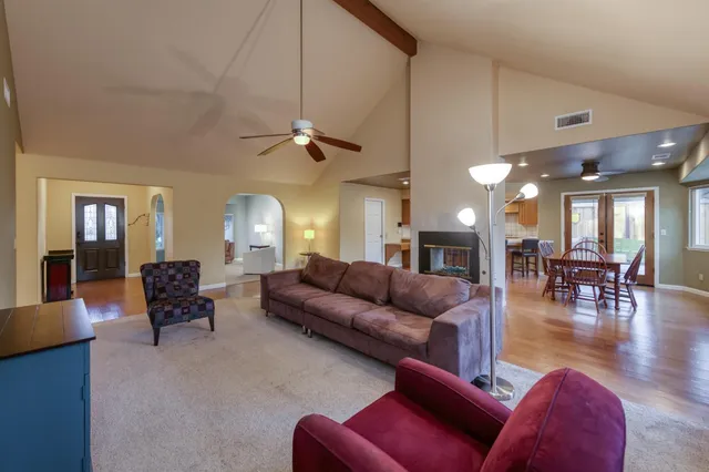 a living room with furniture a dining table and a fireplace