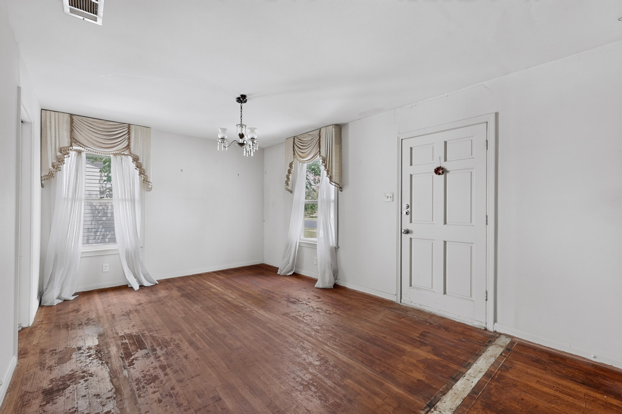 4703 Leslie Avenue Austin, TX 78721 - Photo 6 of 34 Original hardwood floors and ample natural light fill this inviting living space.
