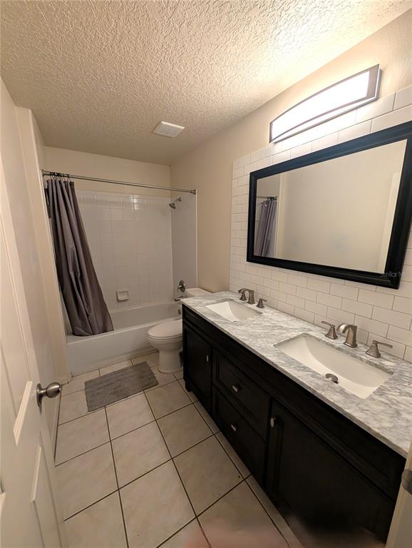 2775 25th Street Sarasota, FL 34234 - Photo 13 of 23 a bathroom with a double vanity sink and mirror