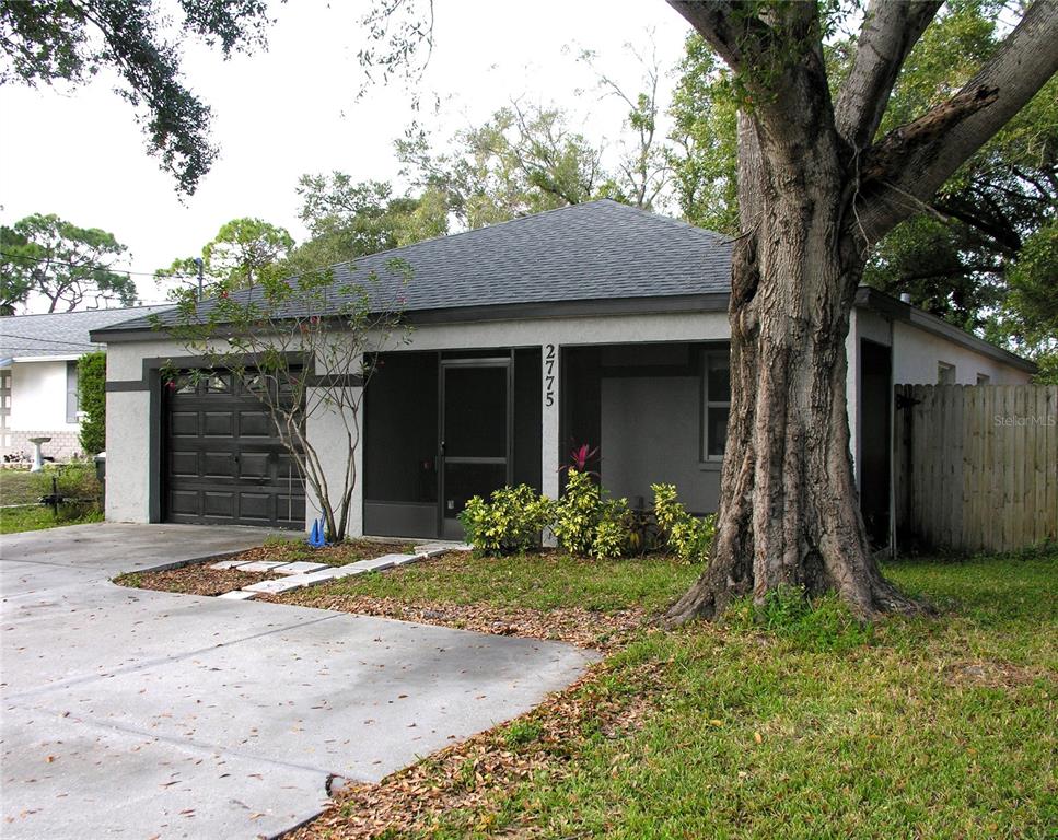 2775 25th Street Sarasota, FL 34234 - Photo 2 of 23 a front view of a house with garden