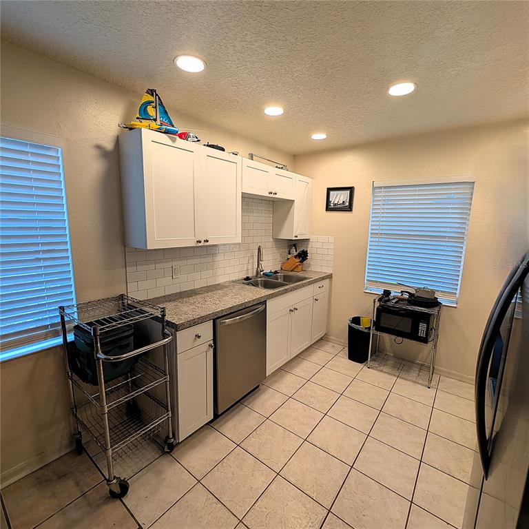 2775 25th Street Sarasota, FL 34234 - Photo 6 of 23 a kitchen with a sink a stove and cabinets