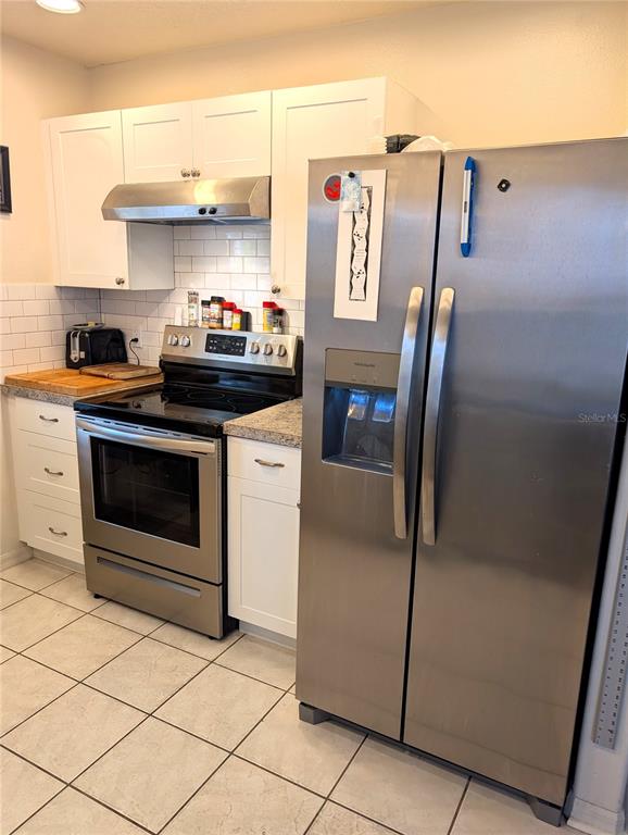 2775 25th Street Sarasota, FL 34234 - Photo 7 of 23 a kitchen with stainless steel appliances granite countertop a refrigerator and a stove