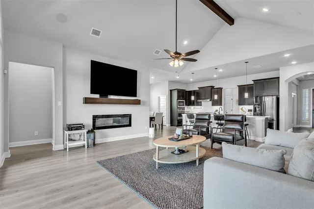 a living room with furniture fireplace and flat screen tv