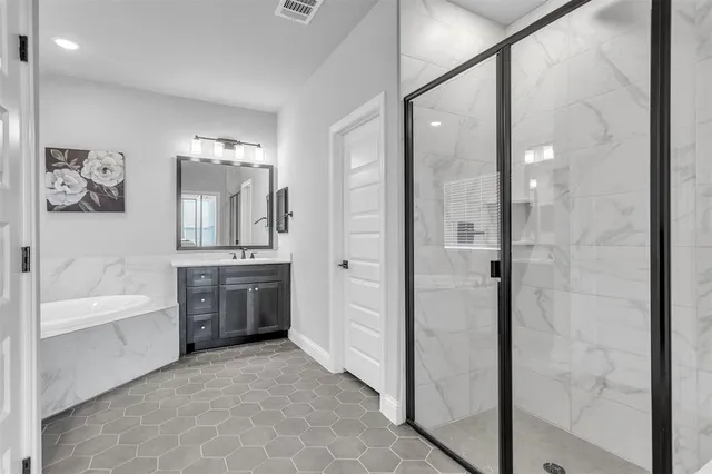a bathroom with a tub a sink and mirrors