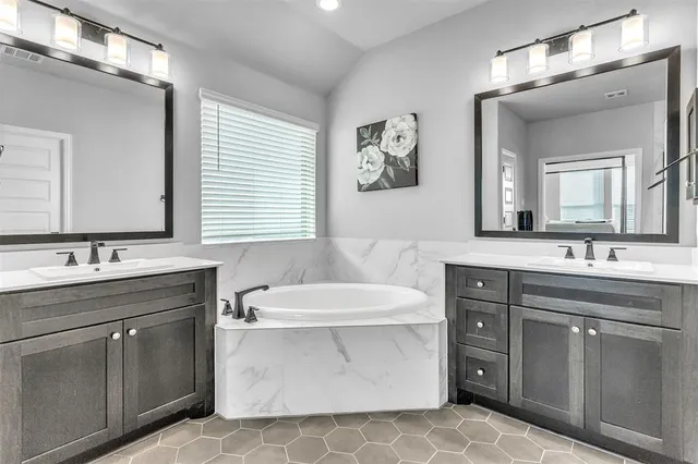 a bathroom with a double vanity sink mirror and