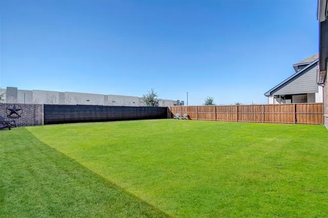 a view of yard with swimming pool and seating