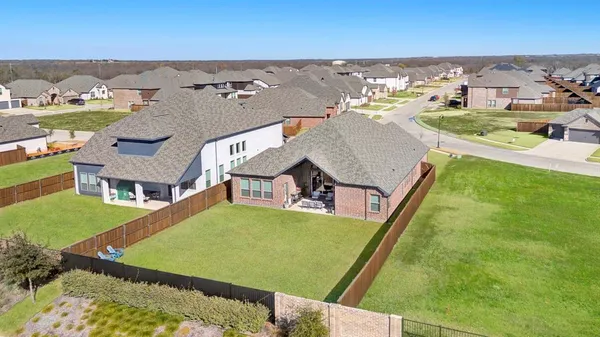 an aerial view of residential houses with outdoor space and swimming pool