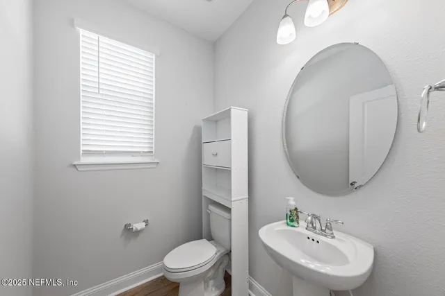 a bathroom with a sink a mirror and a toilet