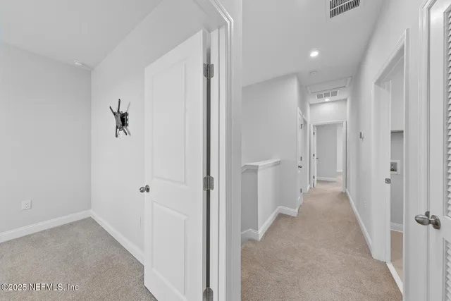 a view of a hallway with two rooms