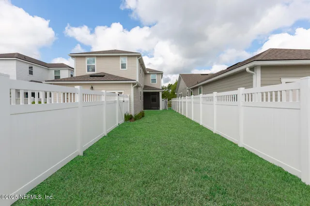 a view of a house with a yard and a porch