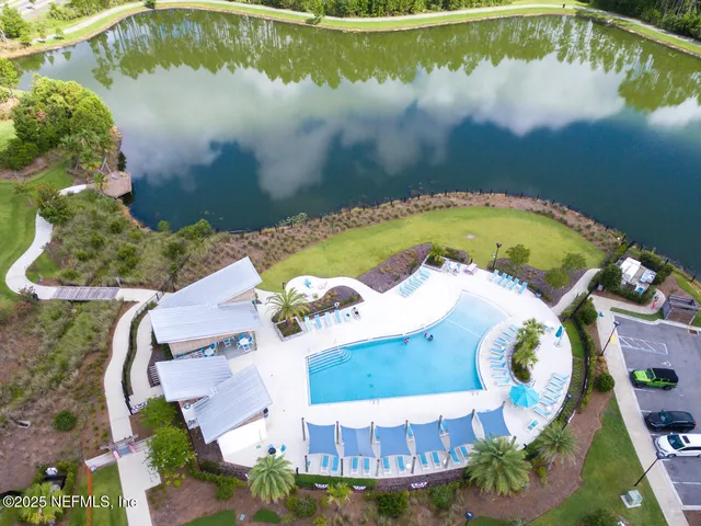 an aerial view of a house with a lake view