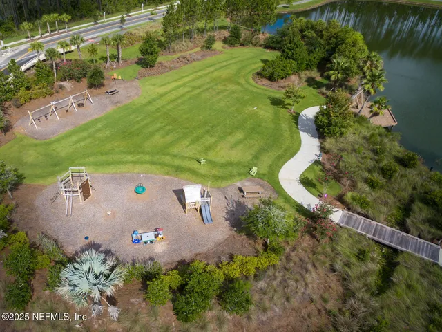 an aerial view of a house with a yard