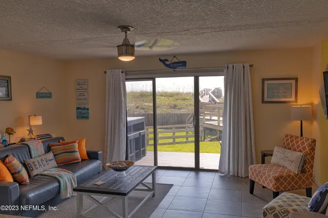 a living room with furniture and a floor to ceiling window