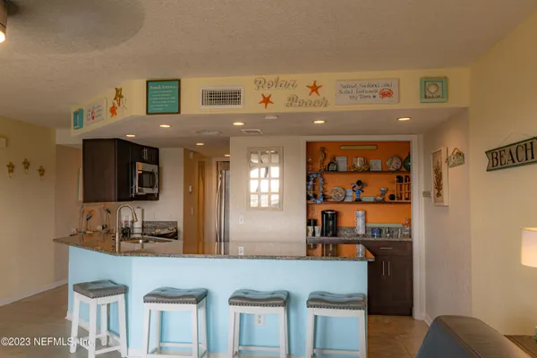 a kitchen with stainless steel appliances granite countertop a refrigerator and stove