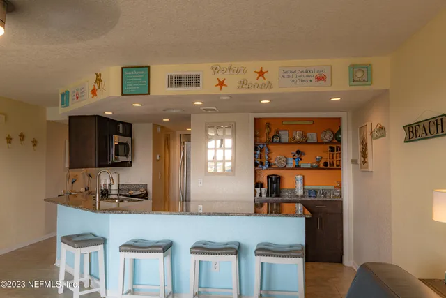 a kitchen with stainless steel appliances granite countertop a refrigerator and stove