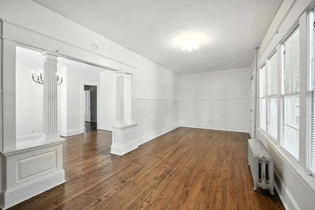 wooden floor in an empty room with a window