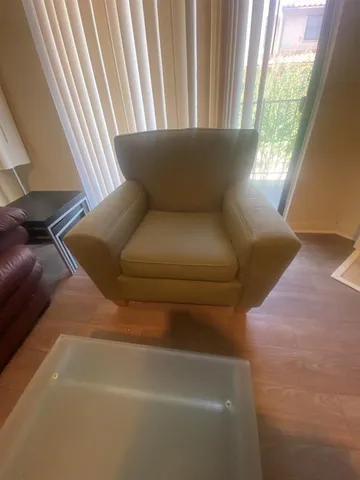 a living room with furniture and a floor to ceiling window