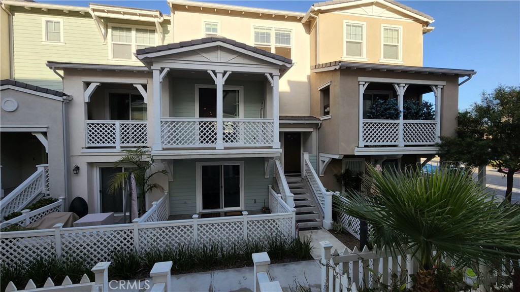 3643 Islander Walk Oxnard, CA 93035 - Photo 1 of 1 a view of a brick house with large windows and a yard