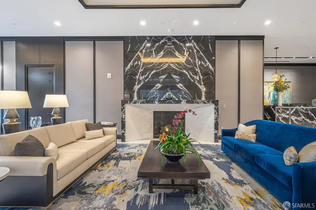 a living room with furniture a flat screen tv and a lamp