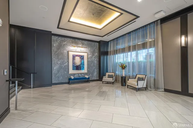 a lobby with furniture and a rug