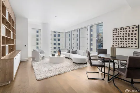 a kitchen with granite countertop white cabinets and white stainless steel appliances