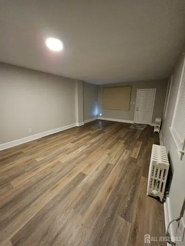 a view of an empty room and wooden floor