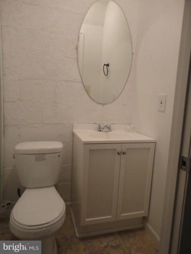 4930 Lindsay Road Baltimore, MD 21229 - Photo 16 of 25 a bathroom with a sink mirror and toilet