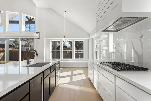 a view of a kitchen with a sink and a large window