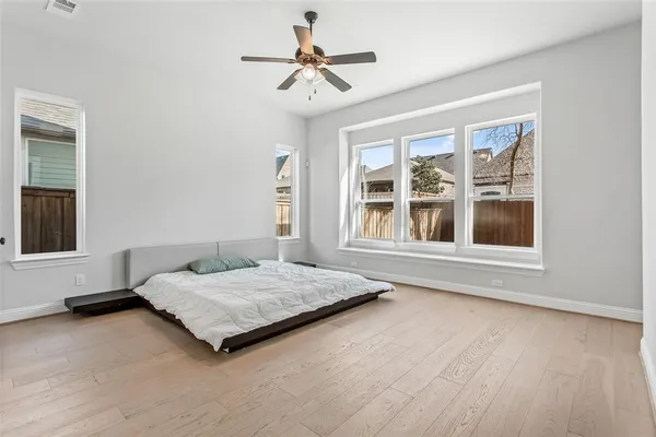 a bedroom with a bed and a large window