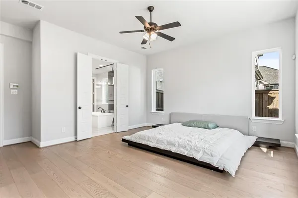 a bedroom with a bed and a ceiling fan
