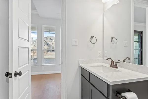 a bathroom with a sink vanity and a mirror