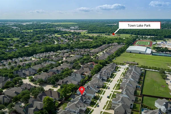 an aerial view of a residential houses with outdoor space and street view
