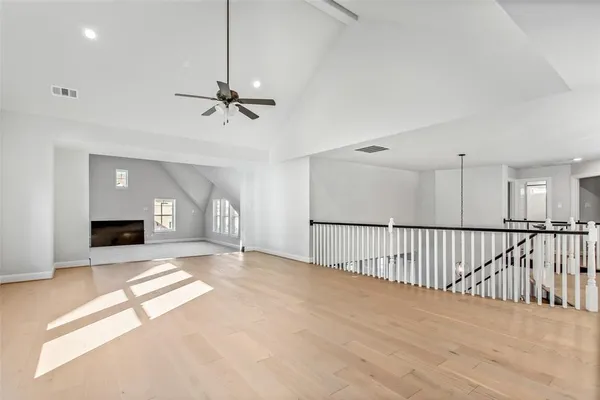 a view of an empty room with a fireplace and a window