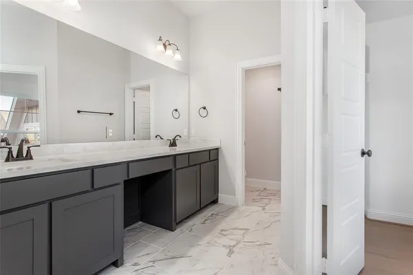 a bathroom with a double vanity sink a mirror and a