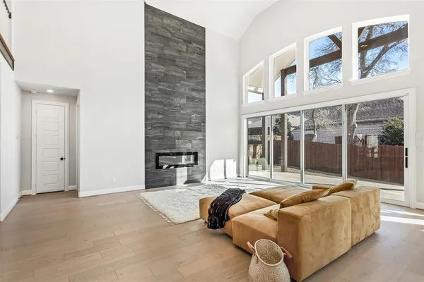 a living room with furniture and a floor to ceiling window