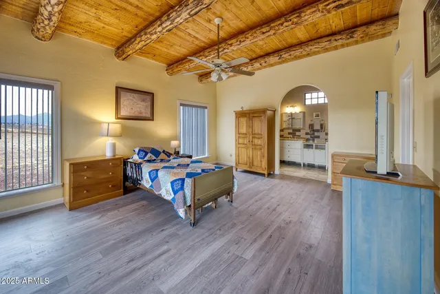 a bedroom with furniture and a wooden floor