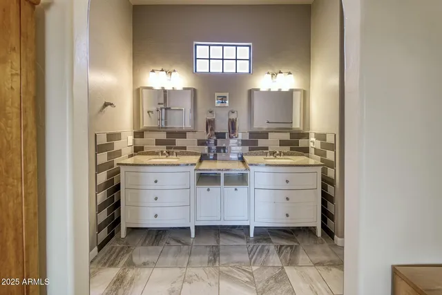 a bathroom with a sink vanity and mirror