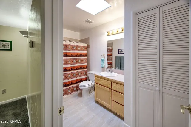 a bedroom with a large bed and a walk in closet